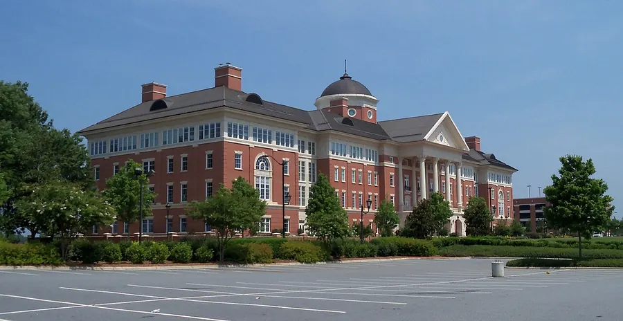 A large red-brick research building with white columns and a copper dome on the North Carolina Research Campus in Kannapolis